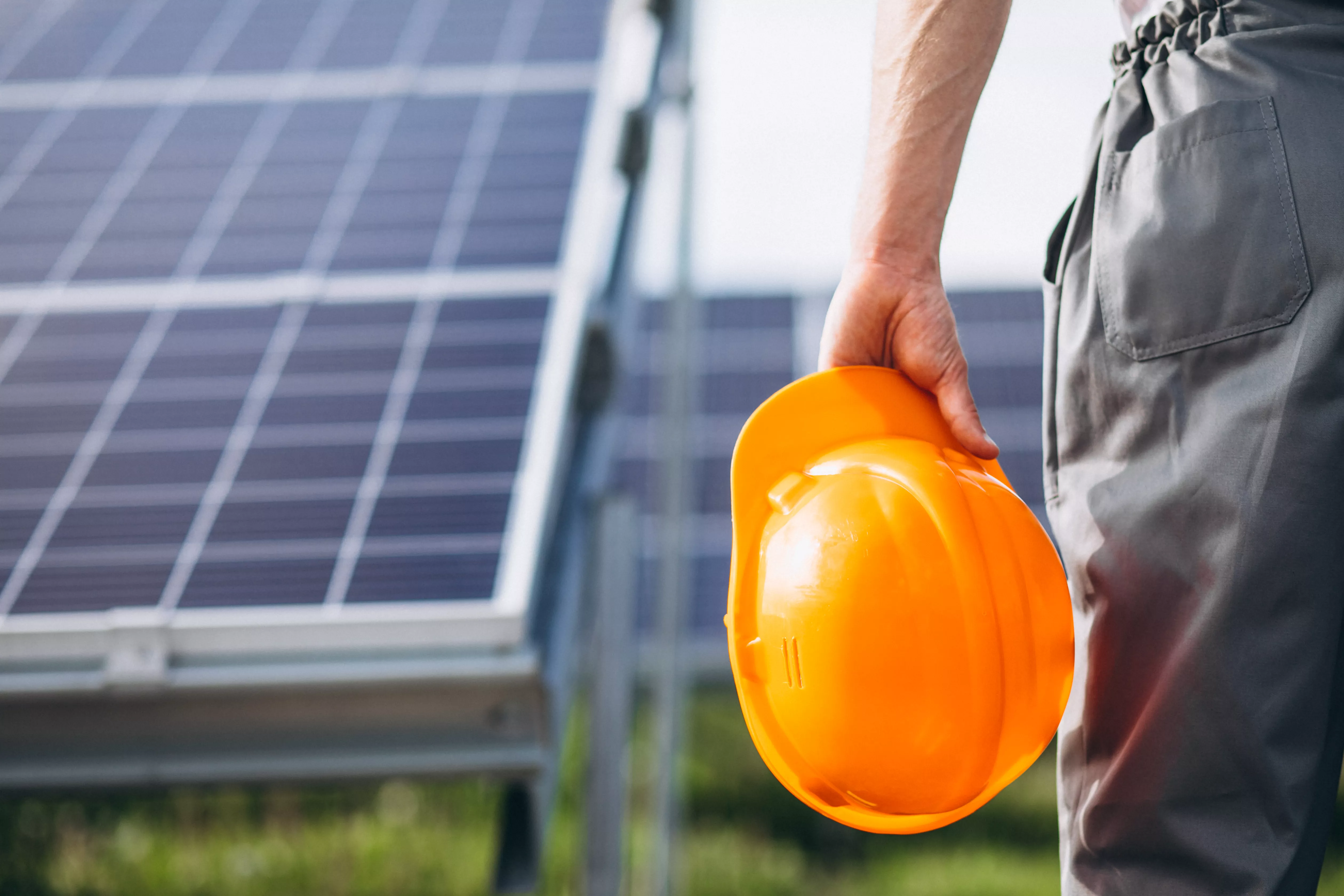 man-worker-firld-by-solar-panels.jpg